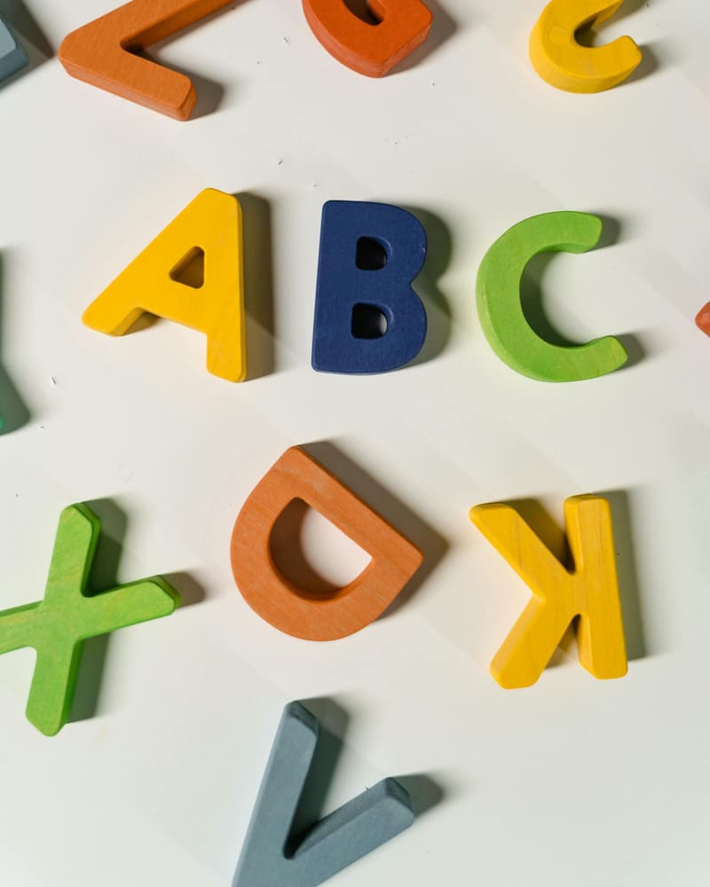 Child using a light-up table with coloured letters